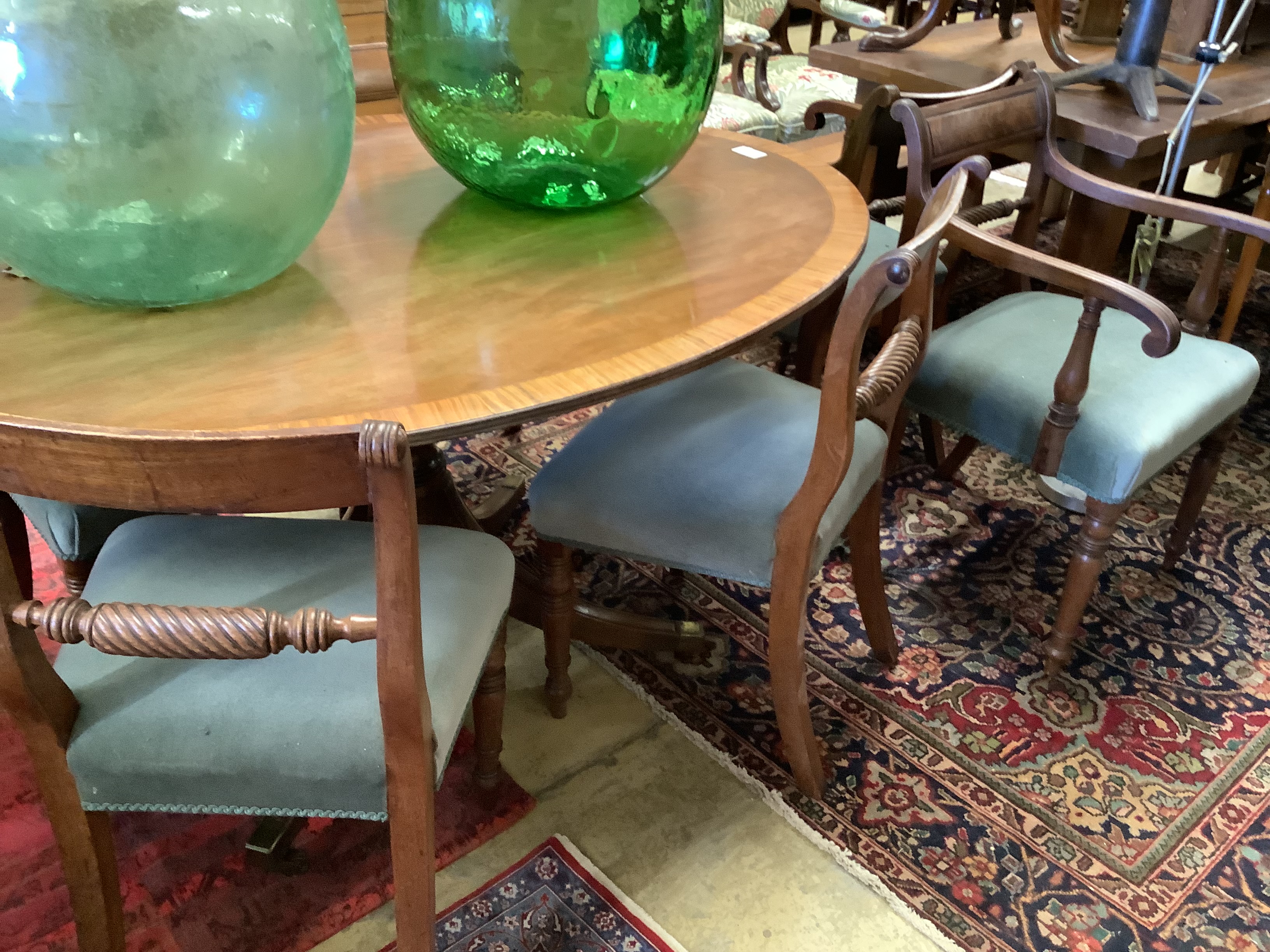 An associated set of six 19th century dining chairs in the Regency style, two with arms